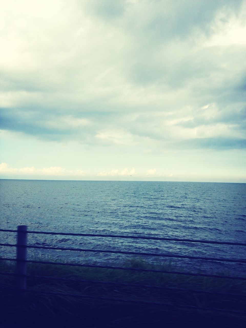 sea, horizon over water, sky, water, tranquil scene, tranquility, scenics, beauty in nature, cloud - sky, beach, nature, cloud, cloudy, idyllic, shore, seascape, calm, remote, outdoors, ocean