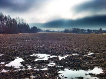 Scenic view of snow covered land against sky