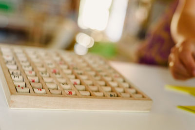 Cropped hand by toy on table