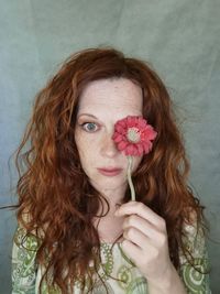 Close-up of young woman holding flower