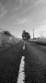 Road amidst trees against sky