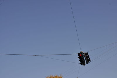 Low angle view of overhead cable car against blue sky