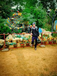 Full length of a man standing against plants