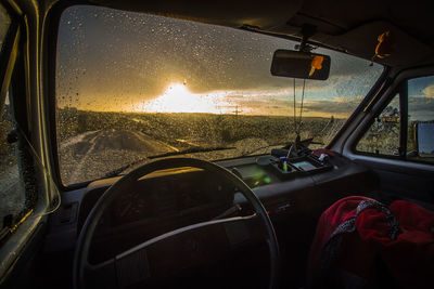 Car on road seen through window