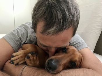 Portrait of woman with dog at home