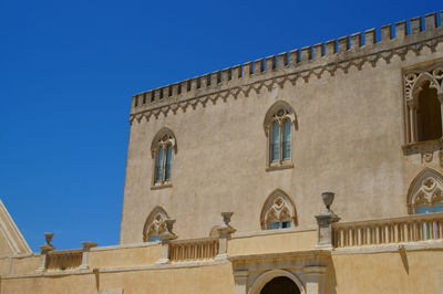 Low angle view of castle against clear blue sky