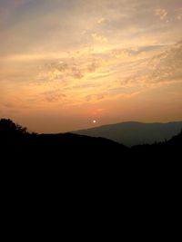 Scenic view of silhouette mountains against sky during sunset