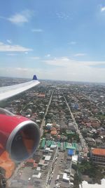 Aerial view of city and buildings against sky