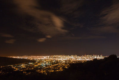 High angle view of illuminated buildings against sky at night