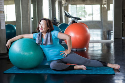 Full length of woman with ball on floor