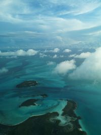 Aerial view of sea and mountains against sky