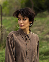 Portrait of young woman standing outdoors