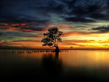 Scenic view of lake against orange sky