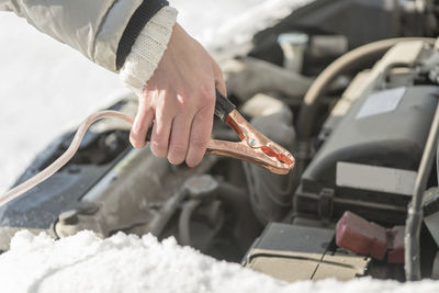 Close-up of hand on snow