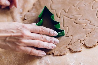 High angle view of hand holding cookies on table