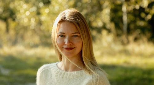 Portrait of young woman standing outdoors