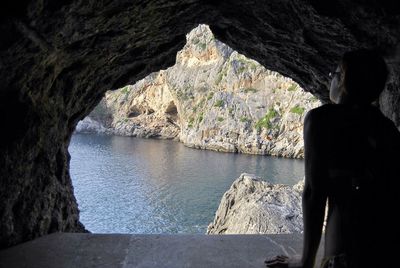 Rear view of man looking at sea