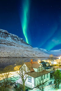 Small village and aurora borealis landscape photo