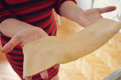 Midsection of woman holding dough