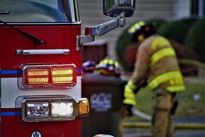 Firefighters standing by fire truck outdoors