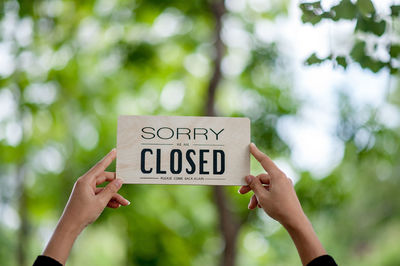 Low section of woman holding text against blurred background