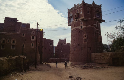 Old buildings in city against sky