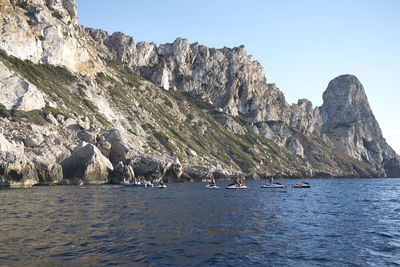 Scenic view of sea and mountains against sky