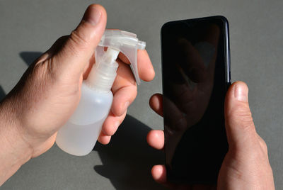 Midsection of man using mobile phone