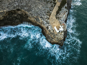 High angle view of water splashing against rock formation