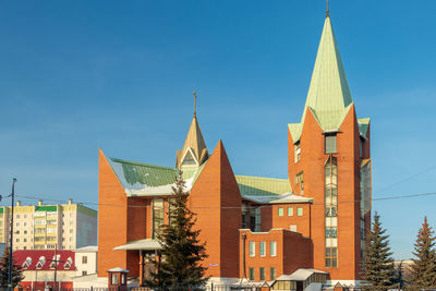 Low angle view of building against clear blue sky