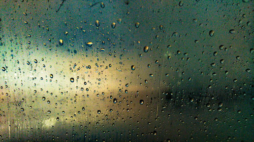 Full frame shot of raindrops on window