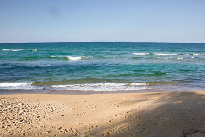 Scenic view of sea against clear blue sky