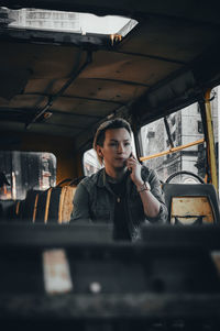 Portrait of young man sitting at home