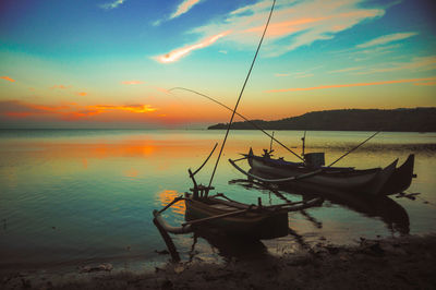 Fishing boats mooring on the beach at sunset, bawean, gresik - indonesia