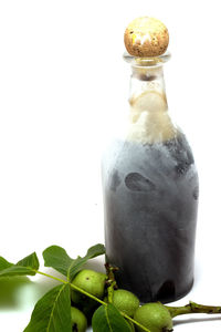 Close-up of bottle on table against white background