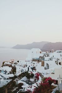 High angle view of buildings by sea against sky