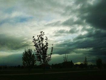 Scenic view of field against cloudy sky