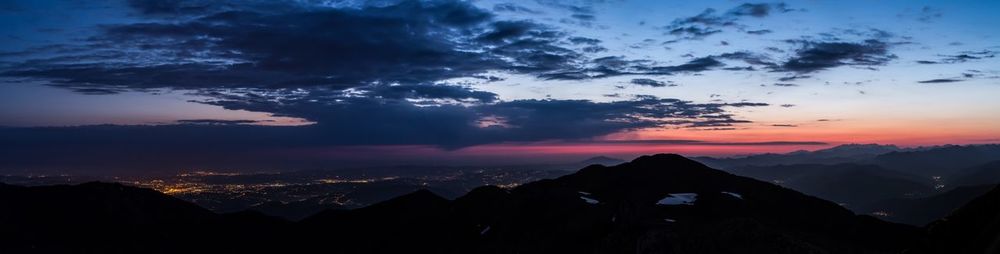 Scenic view of silhouette mountains against sky during sunset