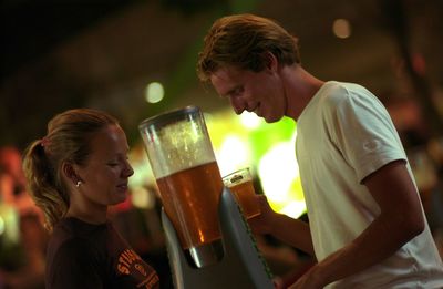 Side view of a young couple drinking glass