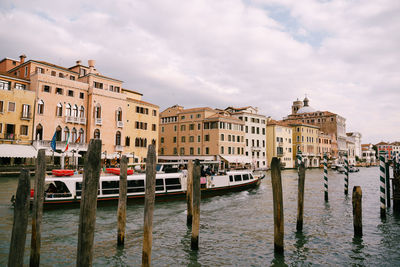 Boats in canal against buildings in city