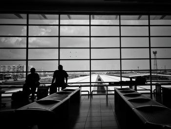 Silhouette people sitting in airport