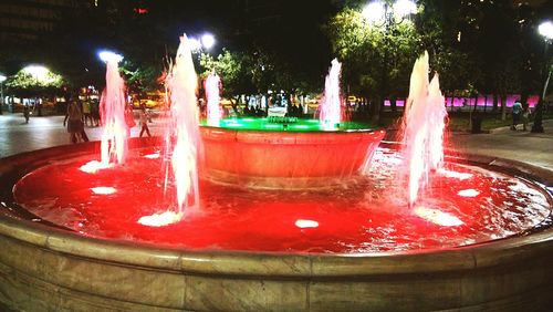 Water fountain in swimming pool at night