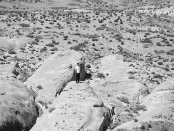 Full length of man standing on rock formation at desert