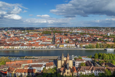 High angle view of townscape by river in city