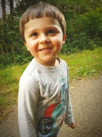 Portrait of smiling boy standing outdoors