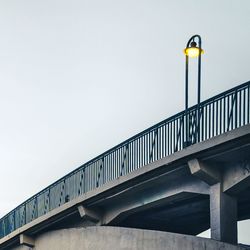 Low angle view of illuminated street light against sky