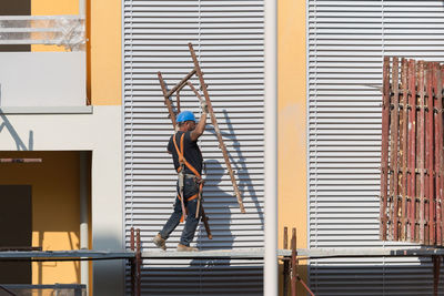 Rear view of woman standing against window