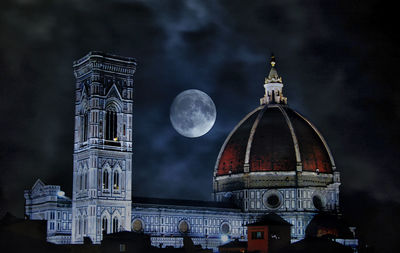 Low angle view of buildings against sky at night