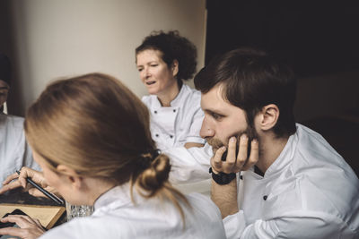 Chefs discussing while sitting in restaurant