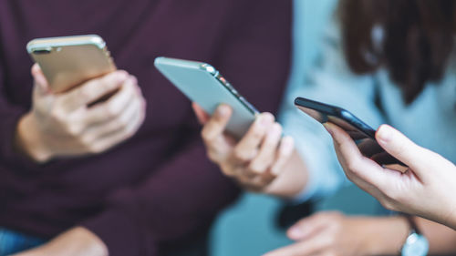 Midsection of man using mobile phone